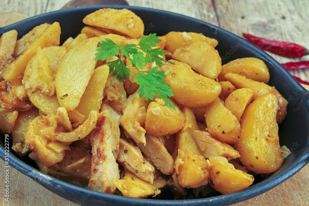 fried potatoes and chicken on a table