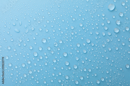 Many water drops on blue background. Texture background.