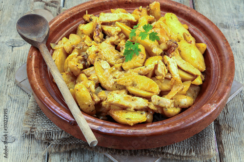 fried potatoes and chicken on a table