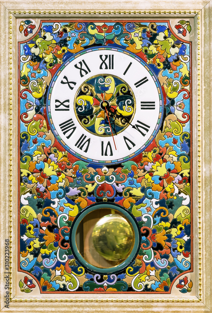 Ceramic clock with bright patterns in a wooden frame.