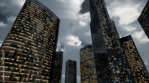 glass skyscrpaer office buildings with dark sky and clouds at storm photo