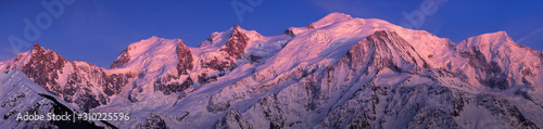 Mont Blanc Massif at twilight. Panoramic view includes Aiguille du Midi, Mont Blanc du Tacul, Mont Maudit, Dome du Gouter, Bossons and Taconnaz Glacier. Haute-Savoie (74), European Alps, France
