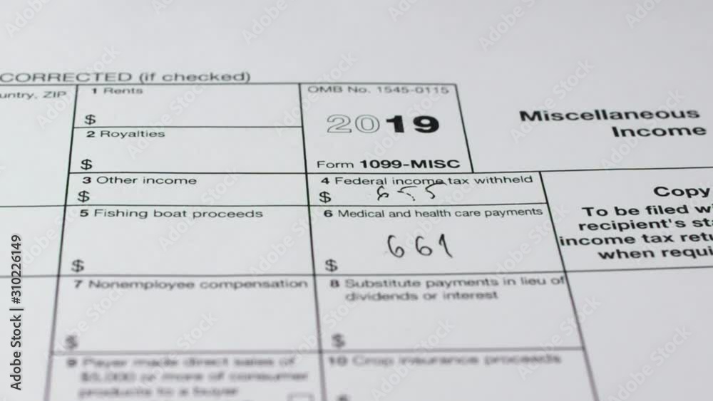 Tax reporting. Human fills out the 1099-misc tax form. Close-up Tax reporting. Human fills out the 1099-misc tax form. Close-up
