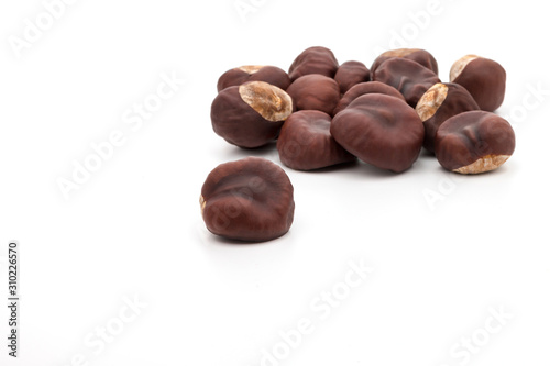 a group of dried chestnuts resembling hearts on a white background