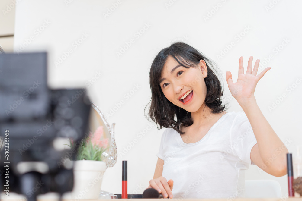 cute blogger japanese girl say hello in front of camera to record video at inside home studio for upload and broadcasting to audience in internet network and website , make-up artist concept cute blogger japanese girl say hello in front of camera to record video at inside home studio for upload and broadcasting to audience in internet network and website , make-up artist concept