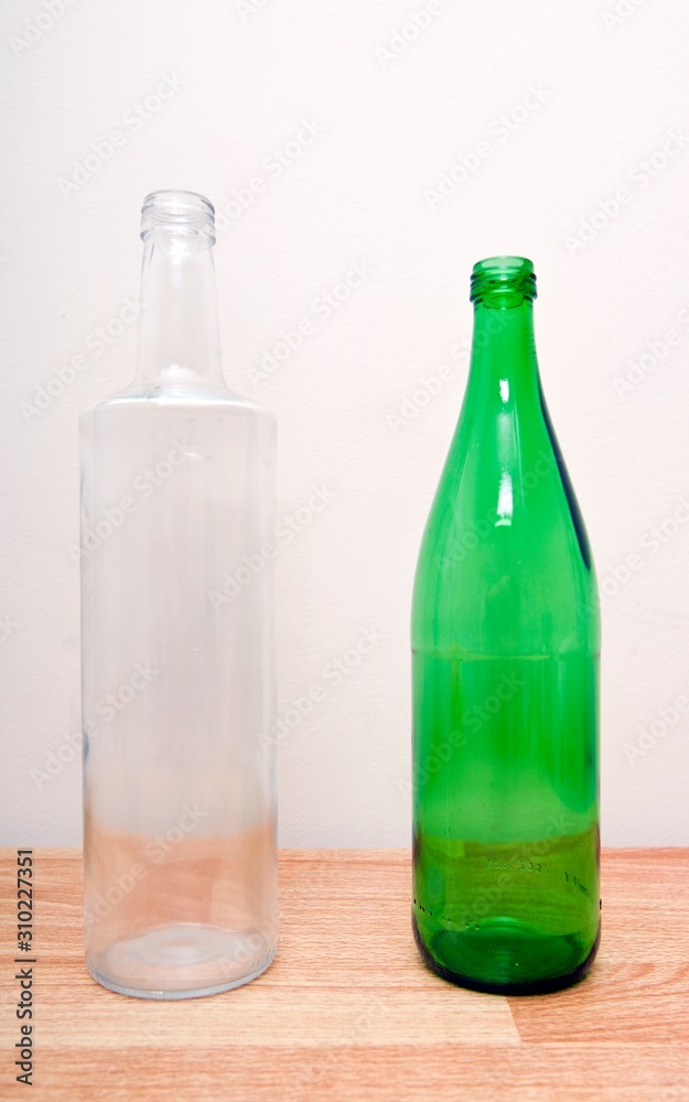 one green glass bottle and one clear glass bottle one green glass bottle and one clear glass bottle