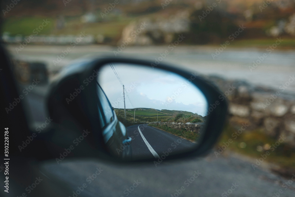 view on road in car mirror