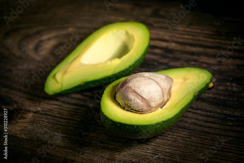 Green avocado on rustic kitchen background