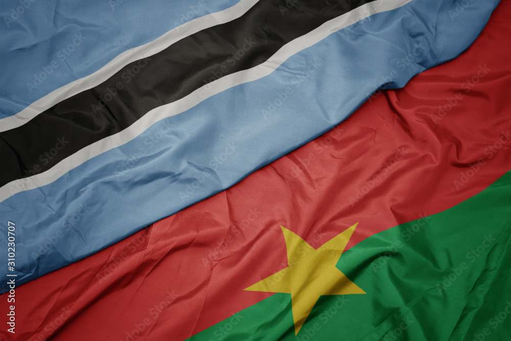 waving colorful flag of burkina faso and national flag of botswana.