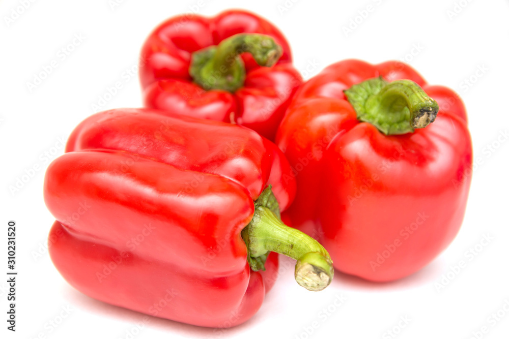Ripe and delicious red bell peppers or paprika isolated over white background. Organic and healthy food concept. Agriculture and harvest. Vegetarian food. Supermarket banner. Selective focus. Ripe and delicious red bell peppers or paprika isolated over white background. Organic and healthy food concept. Agriculture and harvest. Vegetarian food. Supermarket banner. Selective focus.