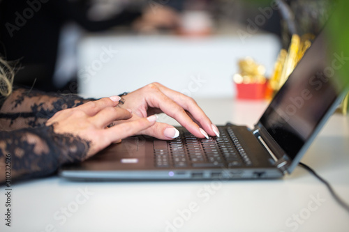 closeup of female hands typing on laptop