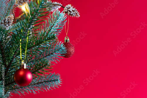 Christmas background with fir tree  frame of twigs christmas tree  brown pine cones on red background with space for text