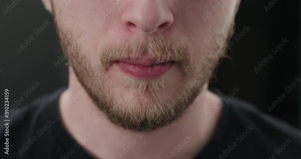 Slow motion closeup shot of bearded man drinking water from glass Slow motion closeup shot of bearded man drinking water from glass
