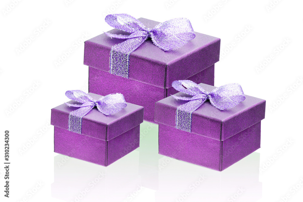 Obraz premium Three hot pink, purple gift boxes isolate on a white background, close-up, reflection
