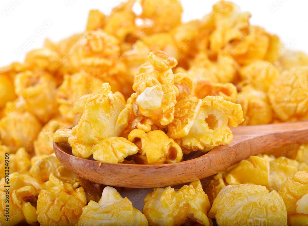 caramel popcorn in wooden spoon caramel popcorn in wooden spoon