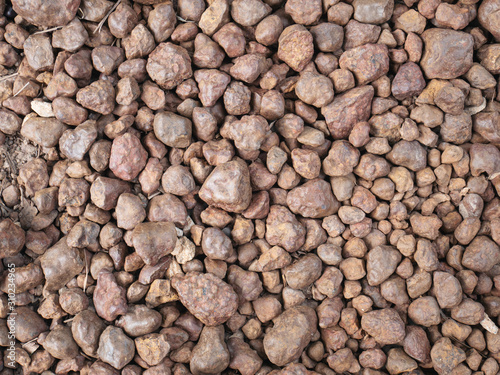 Texture of brown pebbles stone from waterfall.
