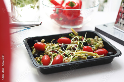 Fototapeta Naklejka Na Ścianę i Meble -  Vegetarian diet box. Salad of colorful fresh vegetables in a lunch box. Box diet. Appetizing lunch boxes. Food delivered to your doorstep