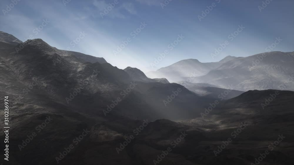 Sunlight rays over mountains in a valley Sunlight rays over mountains in a valley