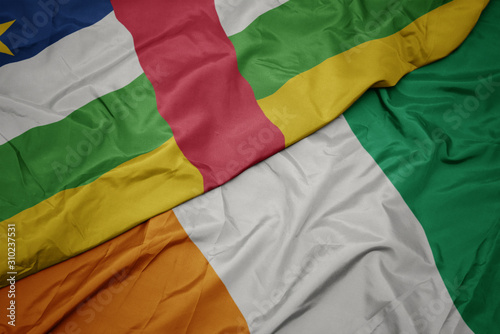 waving colorful flag of cote divoire and national flag of central african republic.