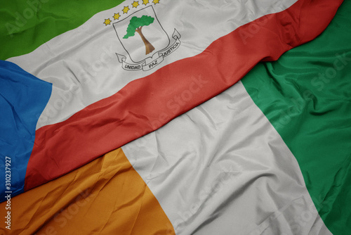 waving colorful flag of cote divoire and national flag of equatorial guinea.