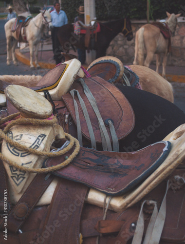 Ixtapan de la Sal, Mexico - Dic 2013 Saddle is a supportive structure for a rider , fastened to an animal's back by a girth. The most common type is the equestrian saddle designed for a horse photo