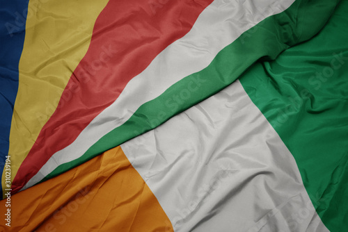 waving colorful flag of cote divoire and national flag of seychelles.
