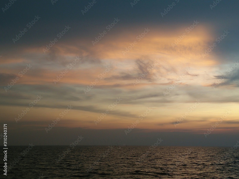 Beautiful sunset sky background on the tropical calm sea. Horizon over the water.