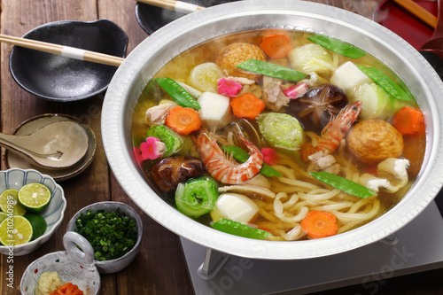 japanese cuisine, udon suki, hot pot with udon noodles and fresh vegetables and seafood