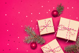 Christmas composition with gifts, branches and holiday elements on the pink background. Flat lay. Merry Christmas, New Year, winter concept.