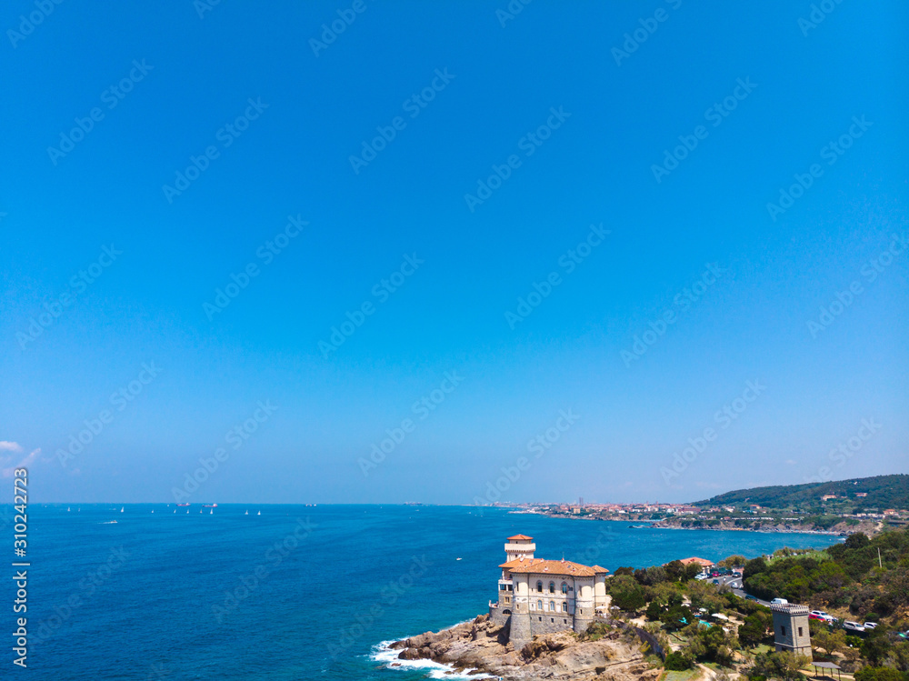 Fototapeta premium Beautiful aerial view of the public beach, a place to relax, people sunbathe, boats go on the water, mediterranena coast in Livorno, Tuscany, Italy