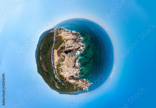 Little planet in blue sky. Beautiful aerial view of the public beach, a place to relax, people sunbathe, boats go on the water, mediterranena coast in Livorno, Tuscany, Italy