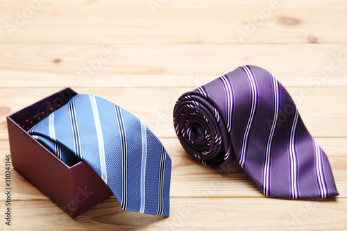 Fotografija Colorful neckties on brown wooden table