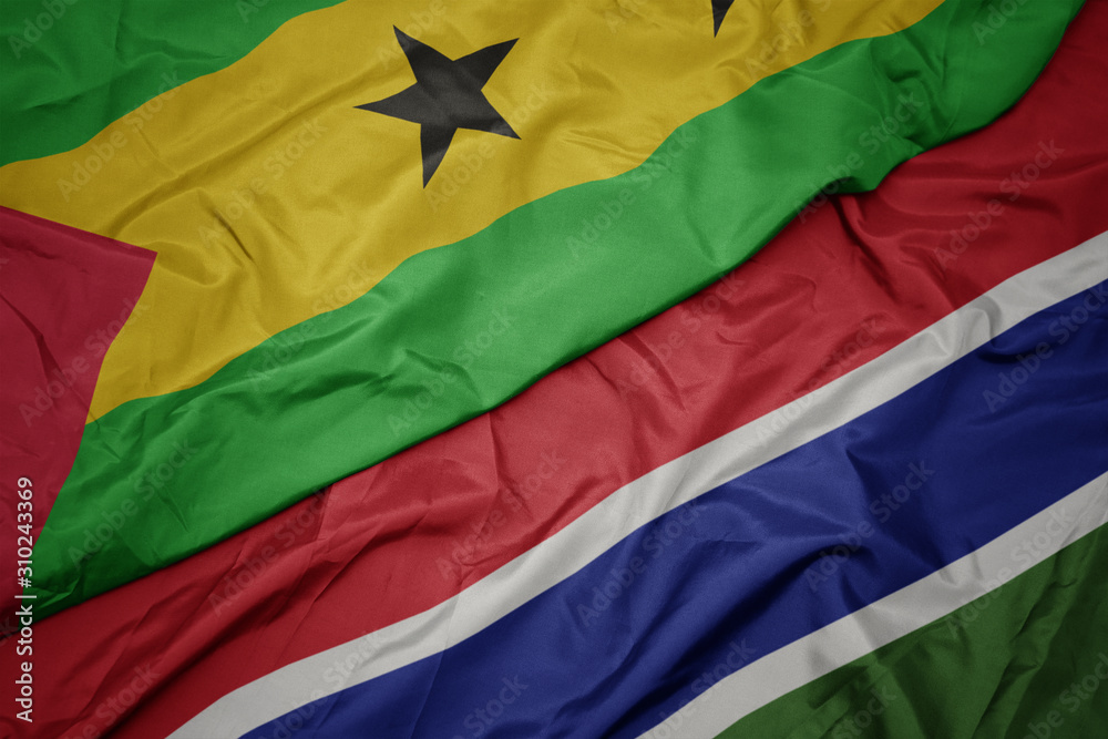 waving colorful flag of gambia and national flag of sao tome and principe .