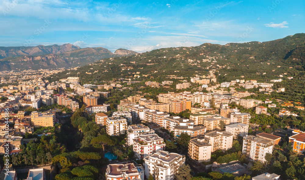 Beautiful panoramic aerial view on the Sorrento city, sunset, houses and streets, mountains and buildings in the distance. Travel and vacation concept on Italy. Infrastructure