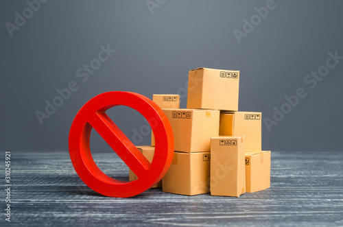 Cardboard boxes and red prohibition symbol NO. Restriction on import, ban on export of dual-use goods to countries under sanctions. Out of stock. Embargo trade wars. Overproduction or scarcity.