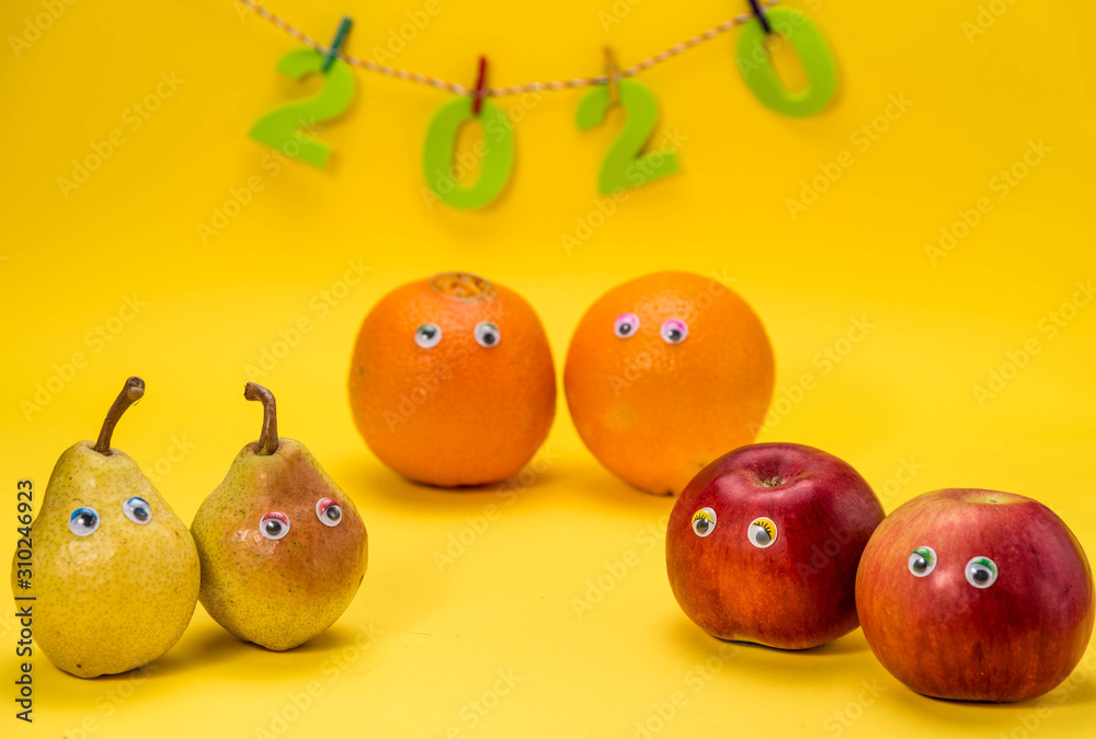 fruit celebrates New Year 2020, pear, orange and two apples