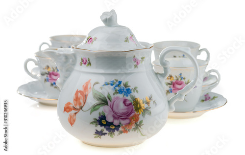 Porcelain teapot with cups on a white background. Selective focus. © vladk213