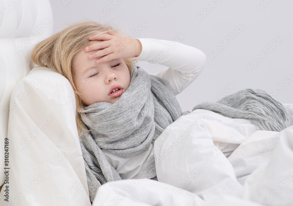 Portrait of sick girl lying in bed and holding hand on head Portrait of sick girl lying in bed and holding hand on head
