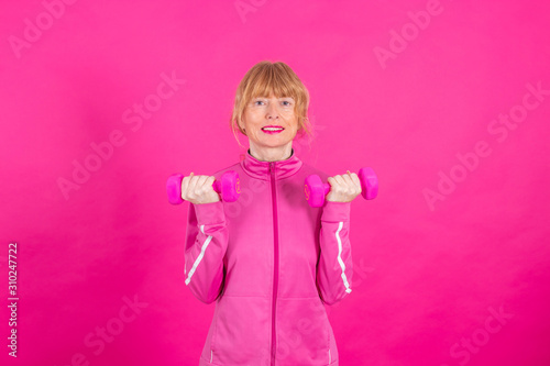 gym dumbbell woman doing sport in color background
