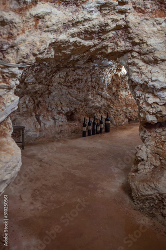 Bottles of wine on the floor of a cave