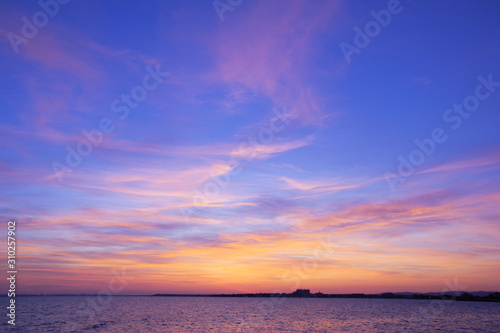 Colorful sunset over the sea. Purple sky.