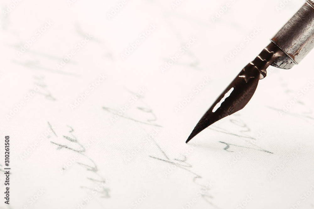 Fototapeta premium Fountain pen on an ancient handwritten letter. Old story. Retro style.