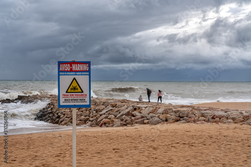 Sign on the beach, no lifeguard protection. Storm in Portugal.