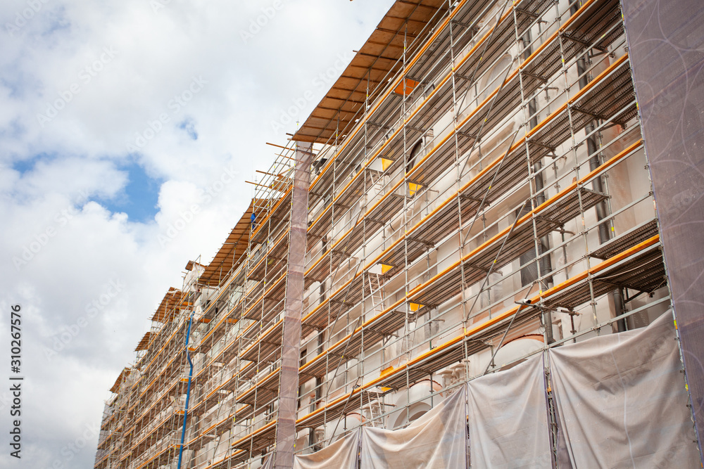 Obraz premium Construction Scaffoldings. Reconstruction of an architectural monument. Historical place.Concrete building.