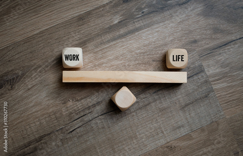 Cubes and dice with work life balance on wooden background