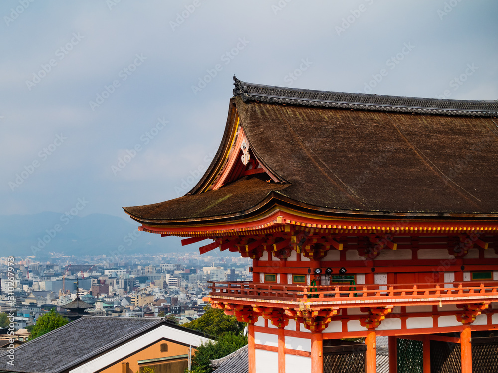 Main Gate of Kiyomizu-dera Temple with brown roof and red wooden base in Kyoto, Japan
