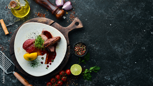 Fototapeta Naklejka Na Ścianę i Meble -  Baked duck fillet with pear and cranberry sauce. Top view. free space for your text. Rustic style.