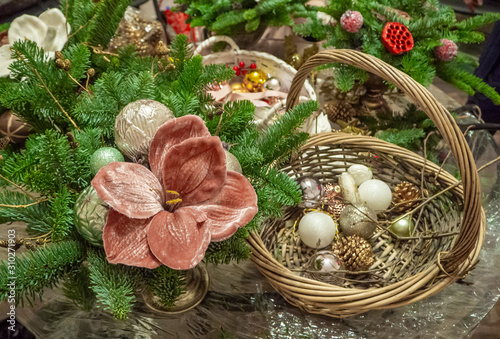 Tablou pe pânză Christmas composition bouquet of fir branches, pink poinsettia flower and balls