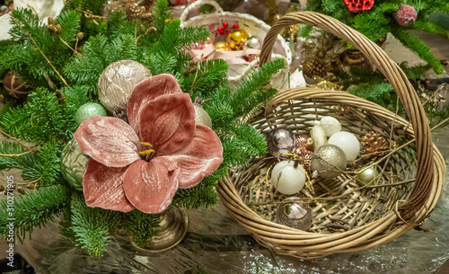 фотографія Christmas composition bouquet of fir branches, pink poinsettia flower and balls