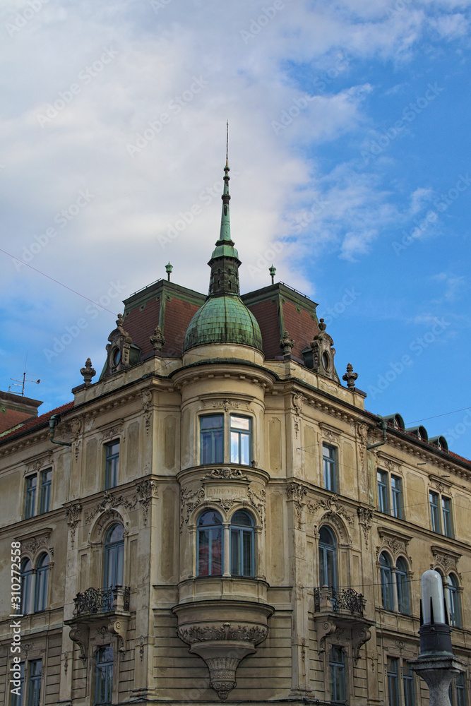 Ancient corner building in the heart of the city near the Triple bridge. Blue sky at sunny autumn day. Architect and landmark concept. Ljubljana, Slovenia Ancient corner building in the heart of the city near the Triple bridge. Blue sky at sunny autumn day. Architect and landmark concept. Ljubljana, Slovenia